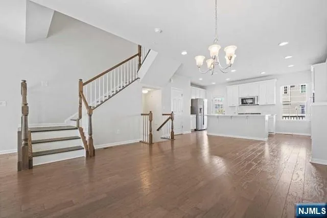 a view of a kitchen with furniture and wooden floor