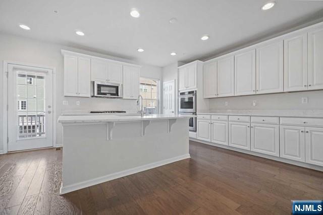32 Truman Drive Wood-Ridge, NJ 07075 - Photo 19 of 49 a large white kitchen with cabinets and wooden floor