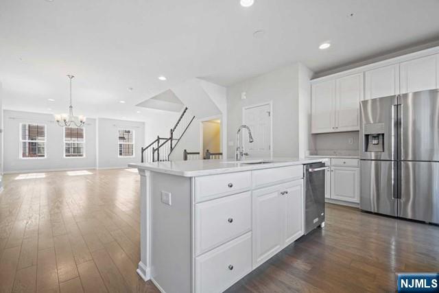32 Truman Drive Wood-Ridge, NJ 07075 - Photo 21 of 49 a kitchen with white cabinets and stainless steel appliances