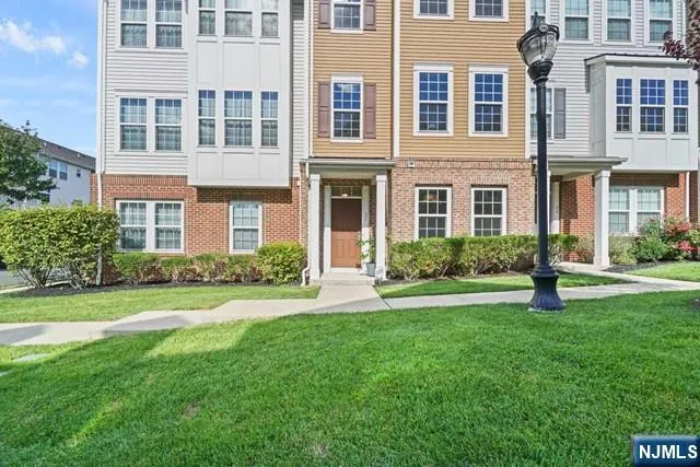 a front view of a residential apartment building with a yard