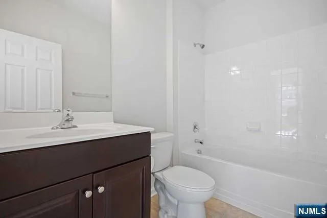 a bathroom with a sink toilet a mirror and shower