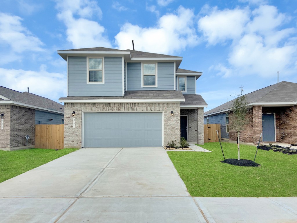 847 Redinger Ridge Drive Huffman, TX 77336 - Photo 1 of 30 a front view of a house with a yard and garage