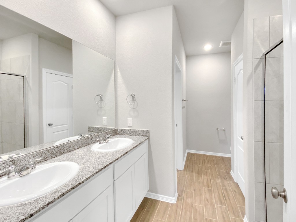 847 Redinger Ridge Drive Huffman, TX 77336 - Photo 12 of 30 a bathroom with a granite countertop double vanity sink and mirror