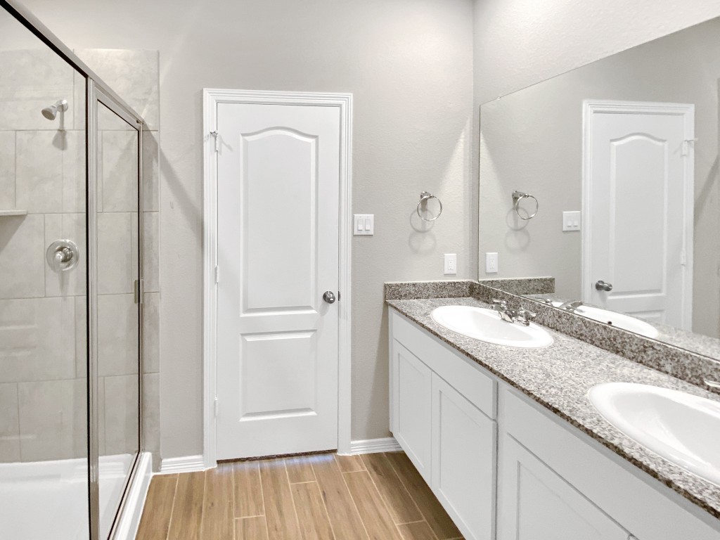 847 Redinger Ridge Drive Huffman, TX 77336 - Photo 13 of 30 a bathroom with a granite countertop double vanity sink and mirror