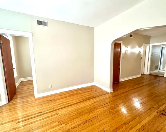 a view of a room with wooden floor
