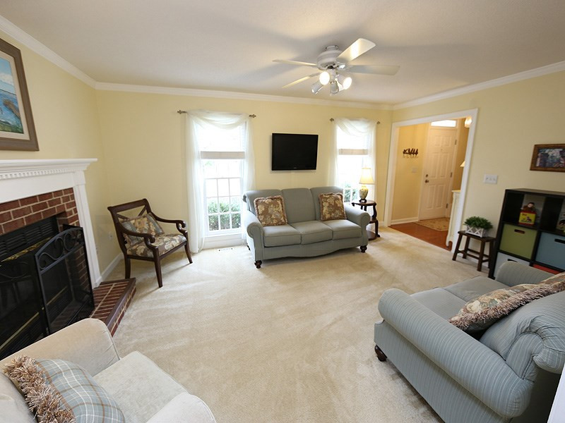 6 Striding Ridge Court Durham, NC 27713 - Photo 2 of 25 The front living room is bathed in natural sunlight with the fireplace as the focal point. Living room