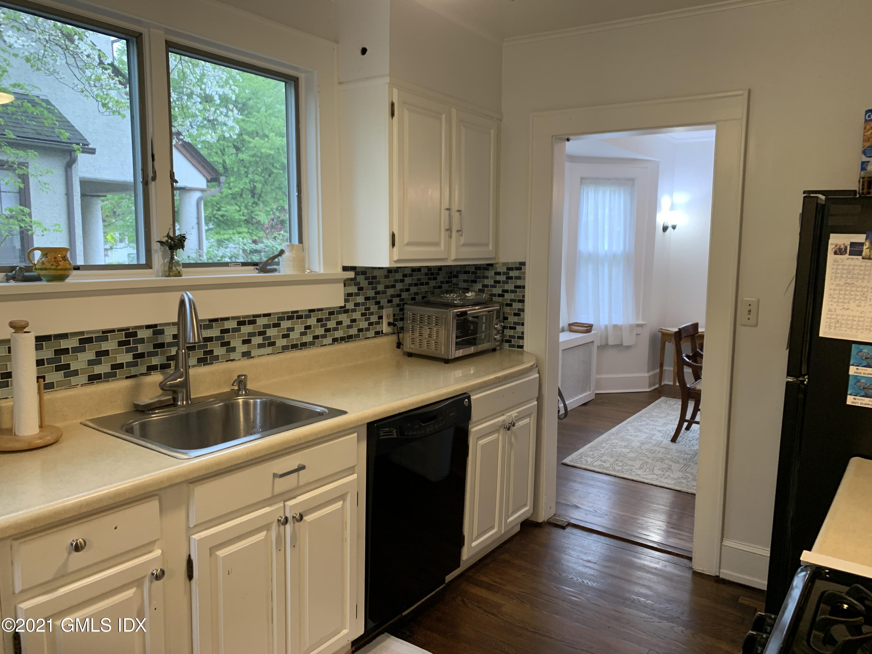 34 Sinawoy Road Cos Cob, CT 06807 - Photo 9 of 16 a kitchen with a sink and cabinets