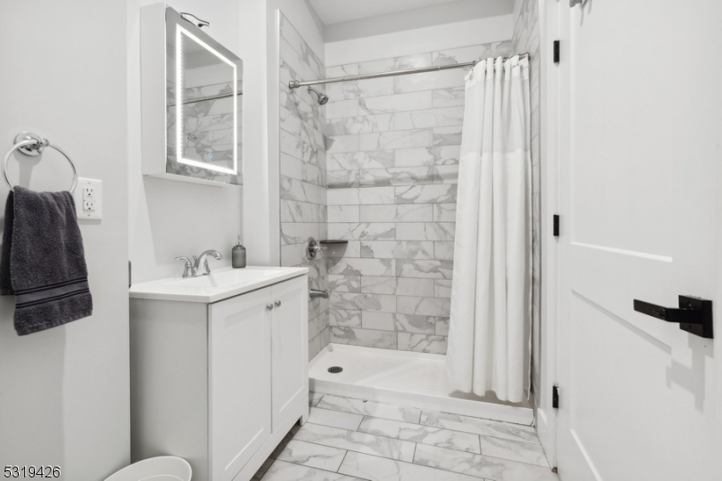 104 Fleming Avenue, Unit 201 Newark, NJ 07105 - Photo 11 of 33 a bathroom with a sink a toilet and shower