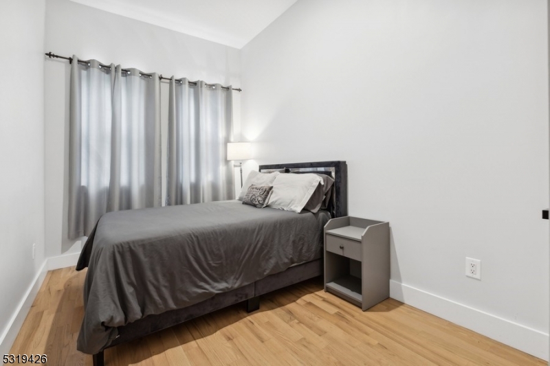104 Fleming Avenue, Unit 201 Newark, NJ 07105 - Photo 14 of 33 a bedroom with a bed chair and a window