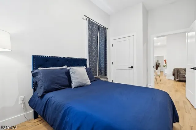 a bed sitting in a bedroom next to a bathroom