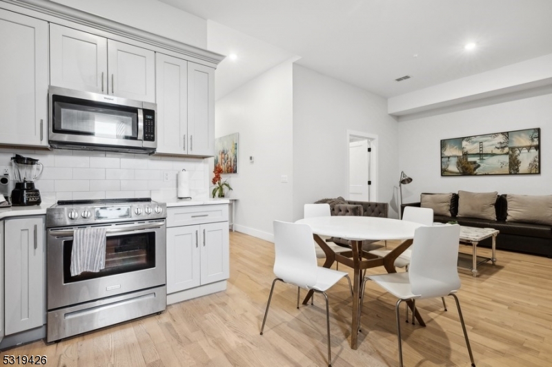 104 Fleming Avenue, Unit 201 Newark, NJ 07105 - Photo 21 of 33 a kitchen with a stove top oven and sink