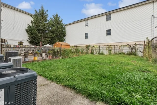 a view of a backyard with plants and trees
