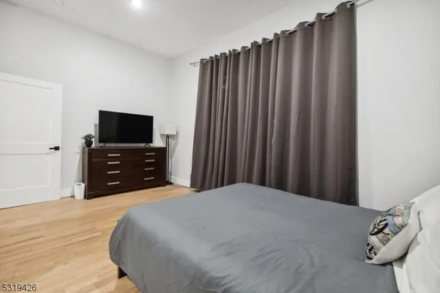 a bedroom with a bed and a television