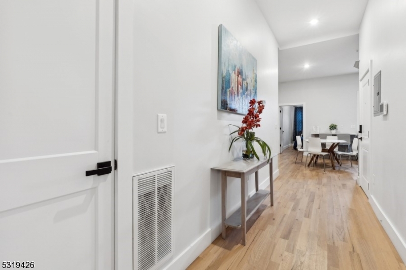 104 Fleming Avenue, Unit 201 Newark, NJ 07105 - Photo 6 of 33 a living room with furniture and a wooden floor