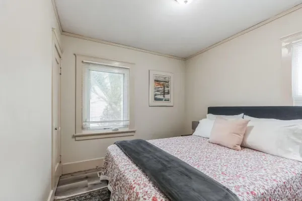a bedroom with a bed and a window