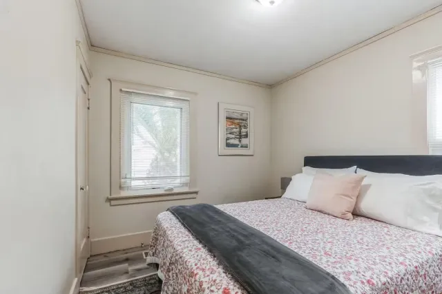 a bedroom with a bed and a window