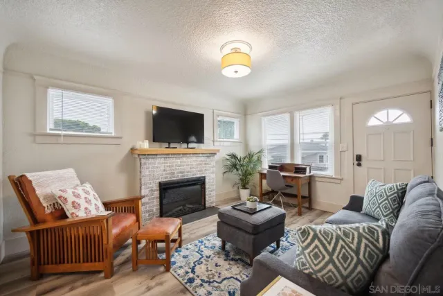 a living room with furniture fireplace and a flat screen tv