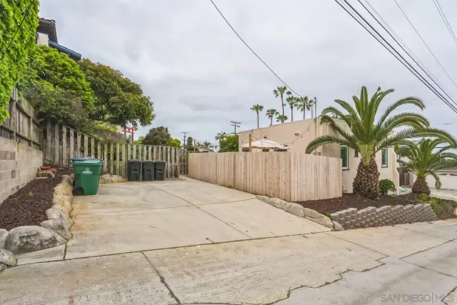 a view of a backyard with wooden fence