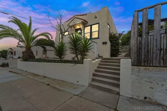 a view of a house with a small yard and plants