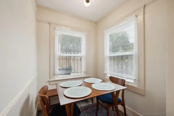 a dining room with furniture and window