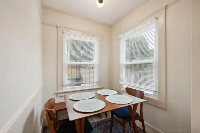 a dining room with furniture and window
