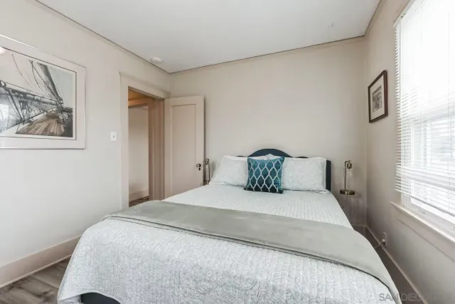 a large bed sitting in a bedroom next to a window