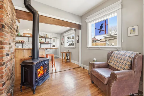 a living room with furniture a rug and a window