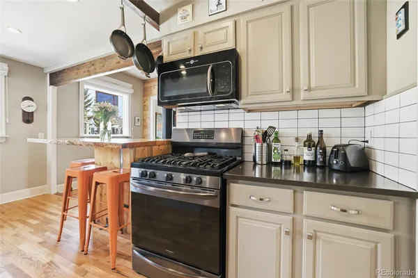 a kitchen with stainless steel appliances granite countertop a stove and a microwave