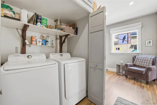 a utility room with dryer washer and a view of living room