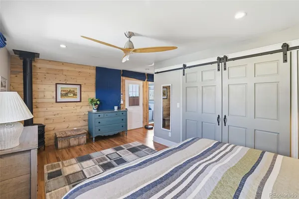 a bedroom with a bed dresser and a window