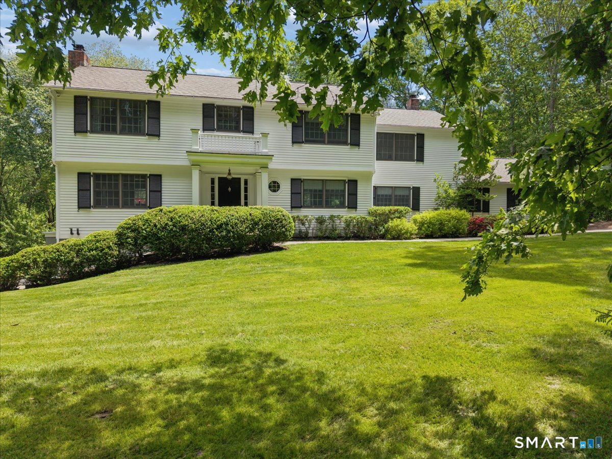94 Vista Road Wilton, CT 06897 - Photo 1 of 38 a front view of house with yard and green space