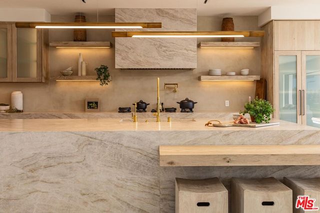 a living room with furniture and large windows