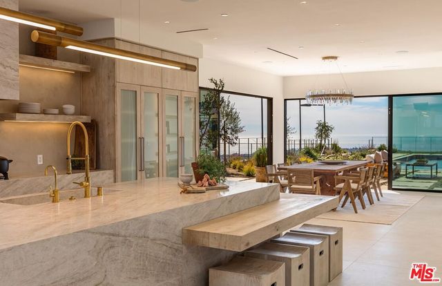 a kitchen with counter top space a sink cabinets and appliances