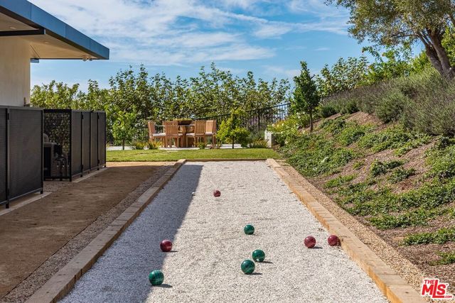 a bathroom with a granite countertop sink toilet and mirror