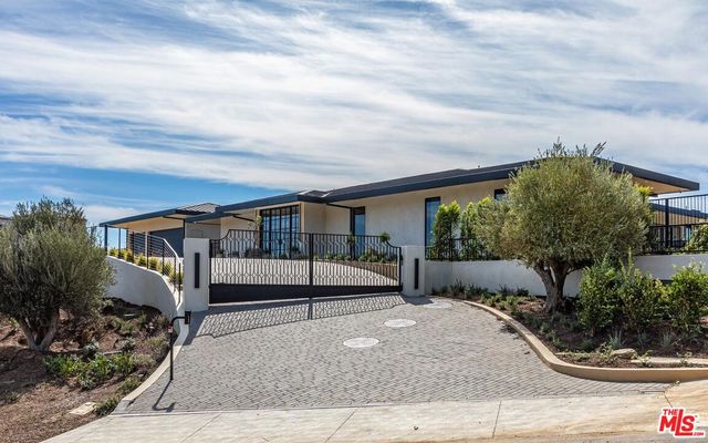 a view of a porch with a table and chairs