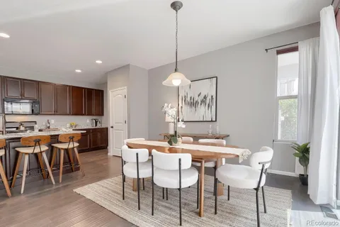 a view of a dining room with furniture window and wooden floor
