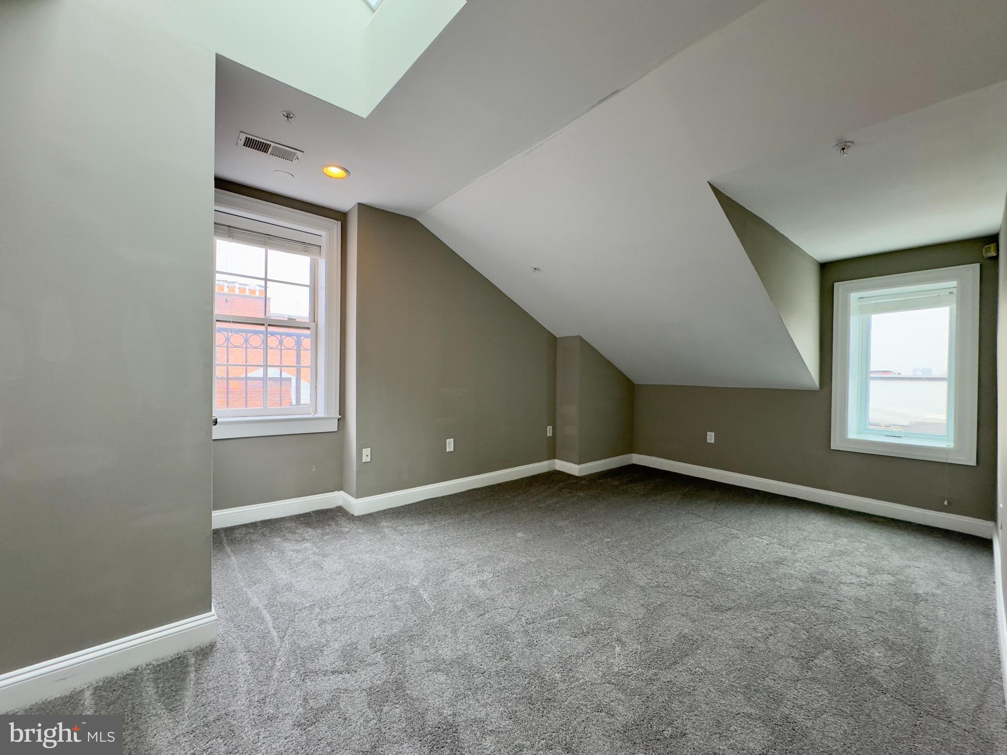 803 Cathedral Street, Unit 9 Baltimore, MD 21201 - Photo 12 of 14 an empty room with windows
