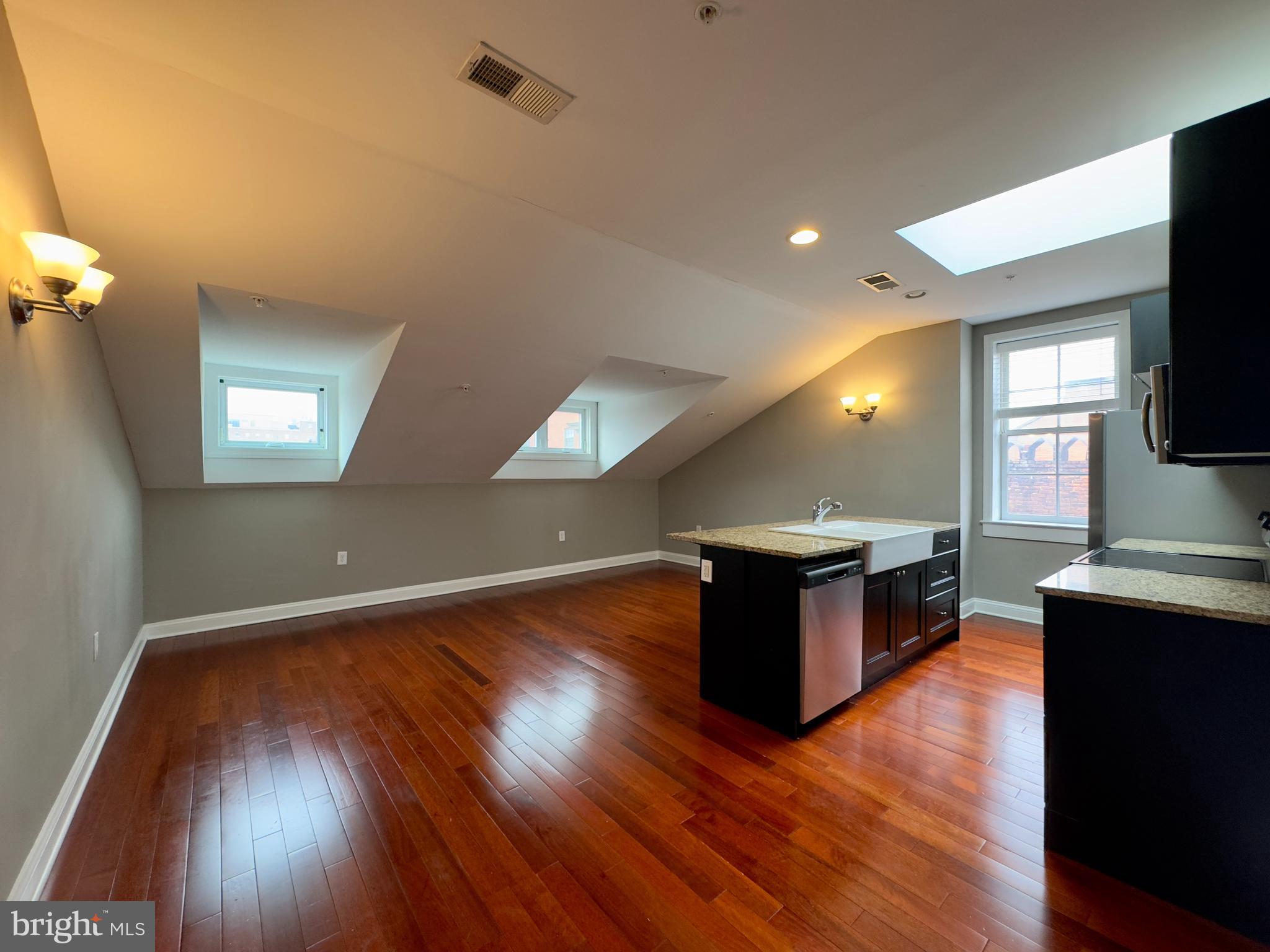 803 Cathedral Street, Unit 9 Baltimore, MD 21201 - Photo 13 of 14 a living room with hard wood floors and a wooden floor