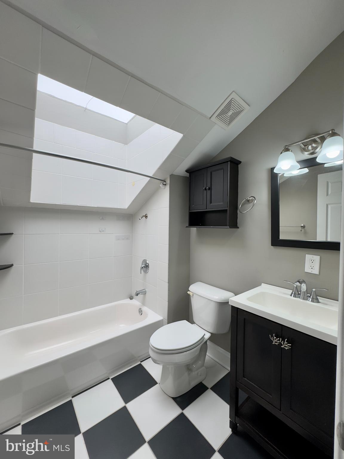 803 Cathedral Street, Unit 9 Baltimore, MD 21201 - Photo 3 of 14 a spacious bathroom with a bathtub sink mirror and toilet