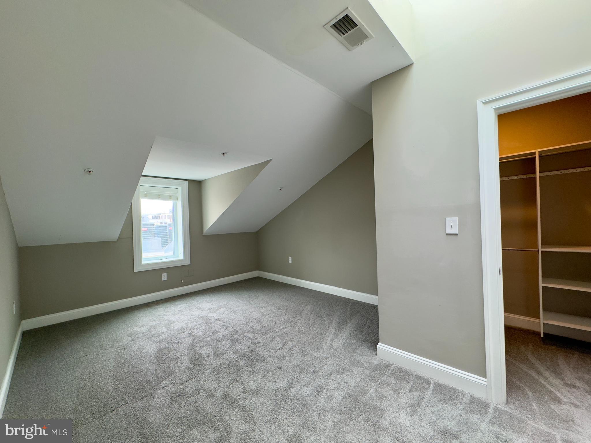 803 Cathedral Street, Unit 9 Baltimore, MD 21201 - Photo 9 of 14 an empty room with windows and closet