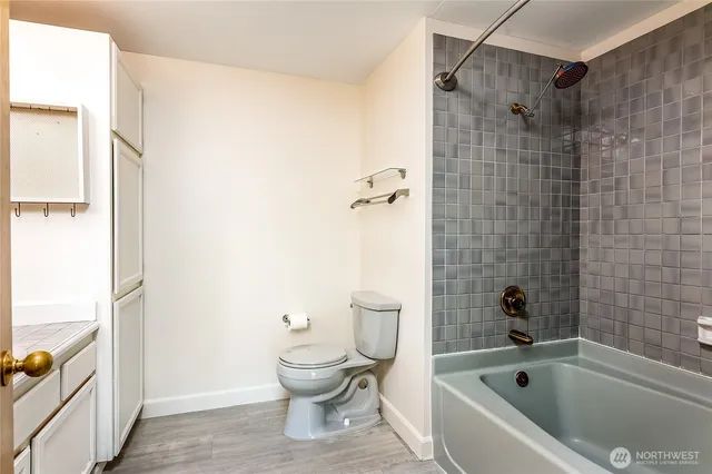 a bathroom with a bathtub and toilet