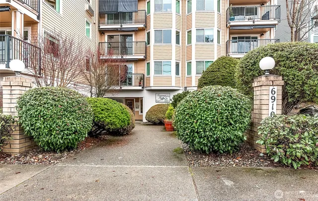 a front view of a multi story residential apartment building with a yard and outdoor seating