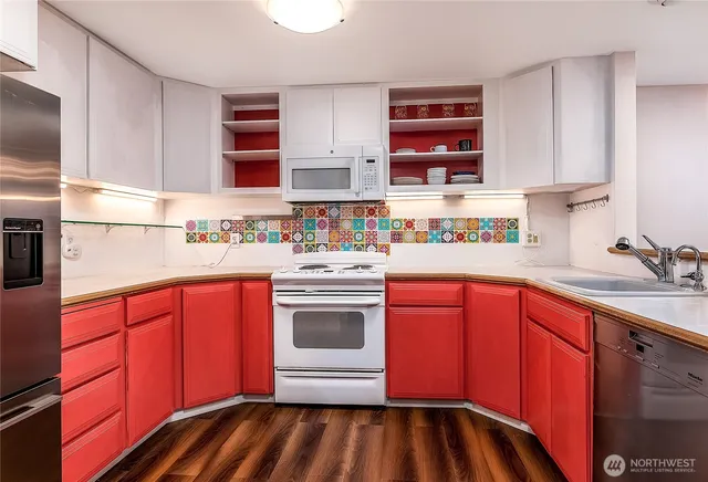 a kitchen with stainless steel appliances a sink stove and cabinets