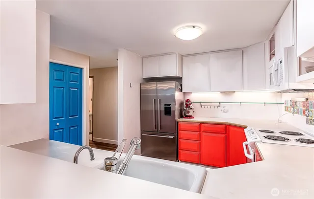 a kitchen with stainless steel appliances granite countertop a sink and refrigerator