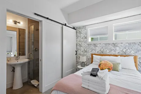 a bedroom with a bed and a mirror