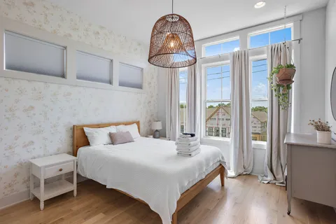 a bedroom with a bed and a chandelier