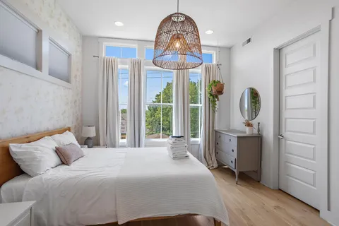 a bedroom with a bed and a chandelier
