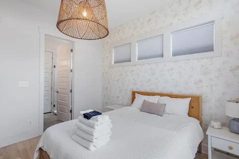 a bedroom with a bed and a chandelier