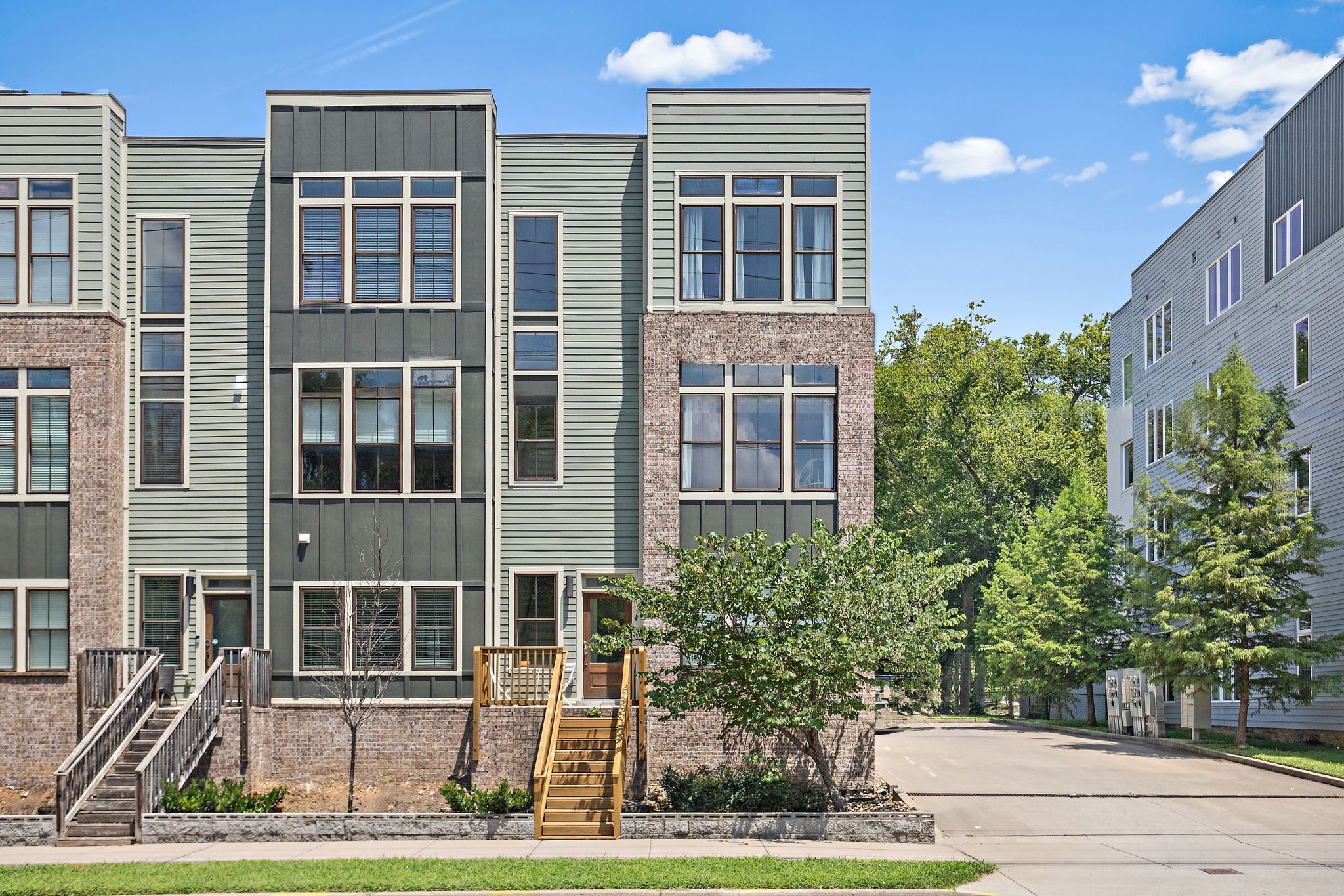1027 East Trinity Lane, Unit 5 Nashville, TN 37216 - Photo 3 of 34 a view of a brick building next to a yard
