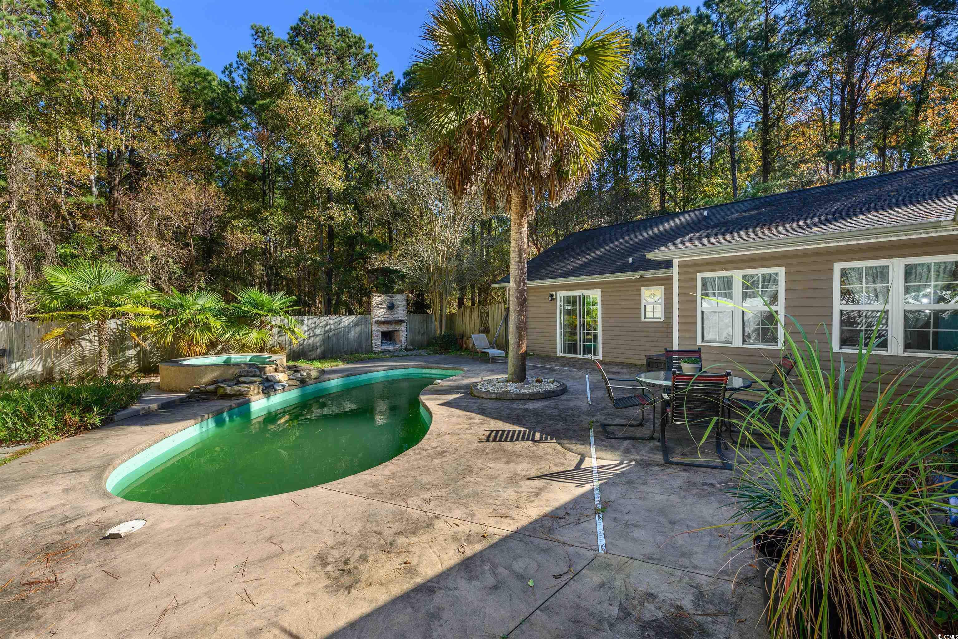 6252 Salem Road Myrtle Beach, SC 29588 - Photo 18 of 39 View of pool featuring a patio and an outdoor fireplace
